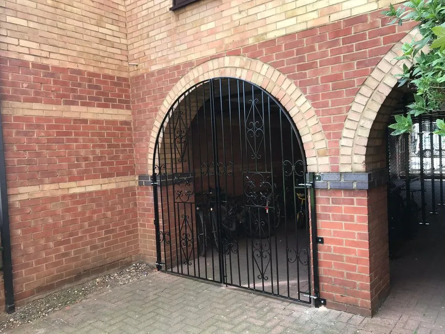 Gate repairs in Harlow to an arched wrought iron gate set into brickwork