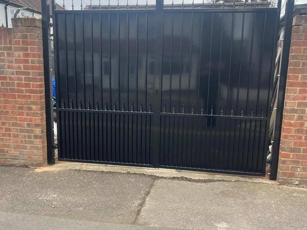 Solid steel commercial gates hung between brick piers